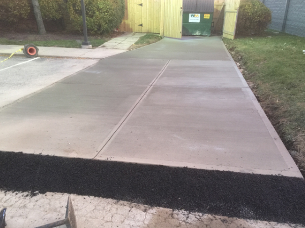 ODC Construction installs concrete pad Kinder Care dumpster concrete pad installation with blacktop removal by ODC Construction